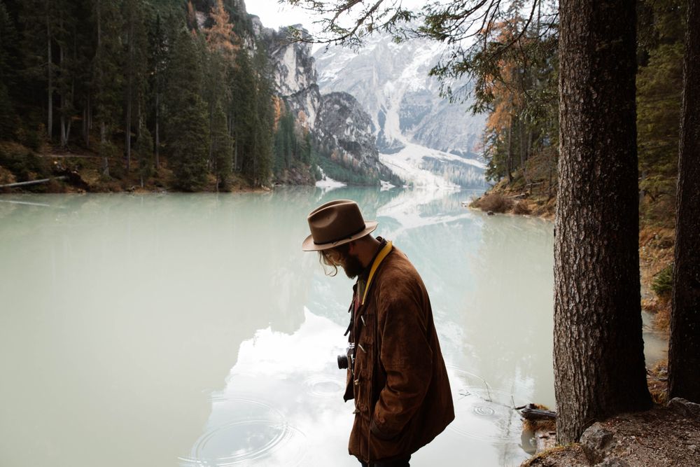 Man delighting in views near lake and mountains