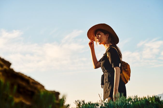 Woman traveler in straw hat walking