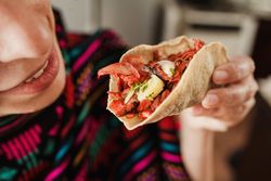 Crop woman with taco al pastor