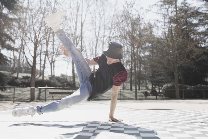 Man dancing break dance in park