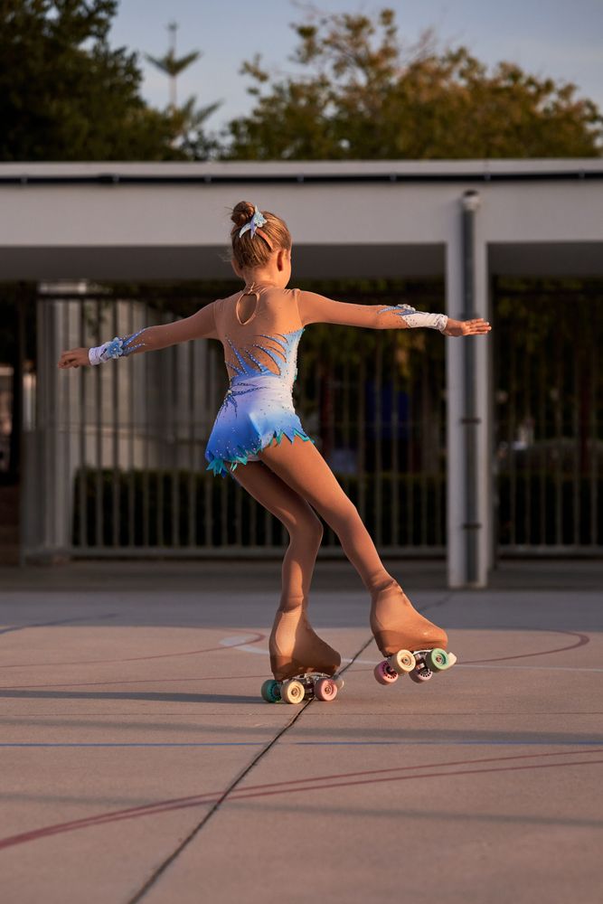 Unrecognizable girl riding roller skates on street
