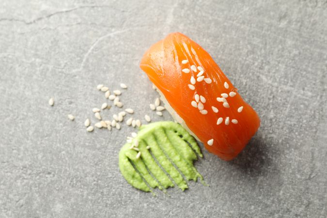Delicious sushi roll and wasabi on gray background. Japanese food