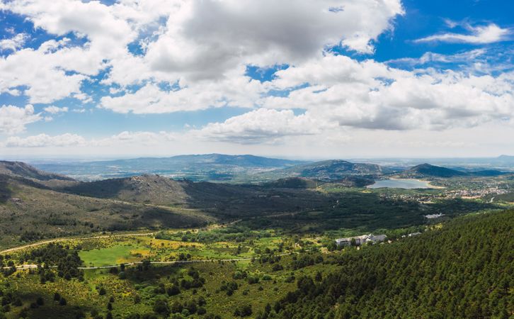 Breathtaking white clouds above hills with greenery