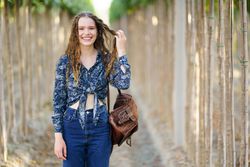 A Charming Young Woman Embracing Nature while Sporting a Stylish and Fashionable Outfit