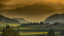 Green grass field near mountain
