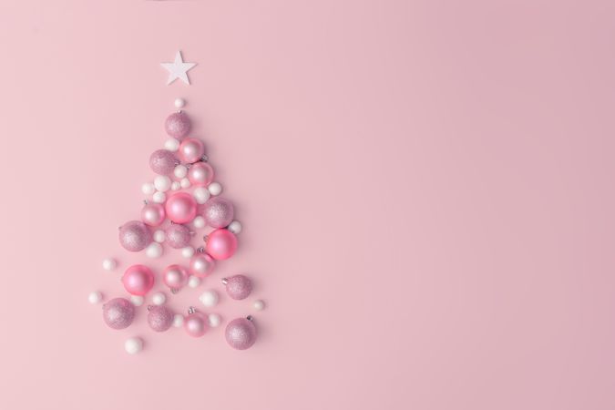 Christmas tree made of pink, purple and shiny glitter ball decoration on pink