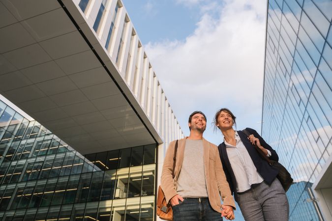Businesspeople couple outside contemporary building