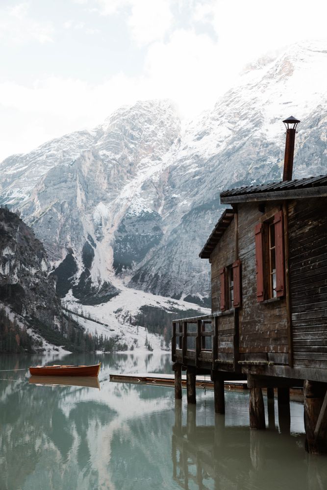 House on stilts on lake near mountains