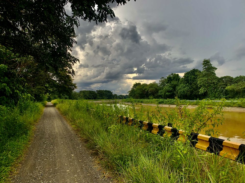 road with river view and cloudy sky