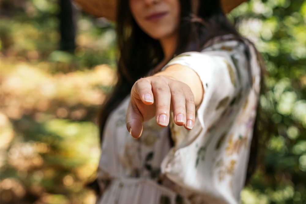 Hand of a woman reaching towards the camera