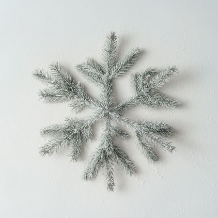 Snowflake made of light-colored Christmas tree branches