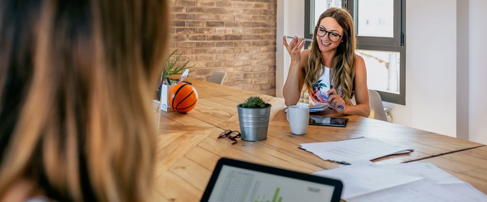 Office worker talking mobile phone with speaker