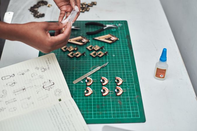 Person constructing earrings