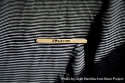 The word “inflation” written on wooden stick laying on striped fabric 41XVZ5