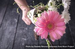 Bouquet of flowers held in unrecognizable hand 49EJy4