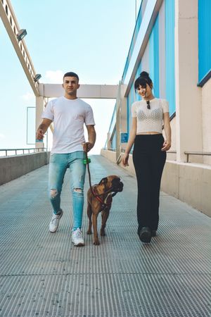 Couple with their Boxer dog.