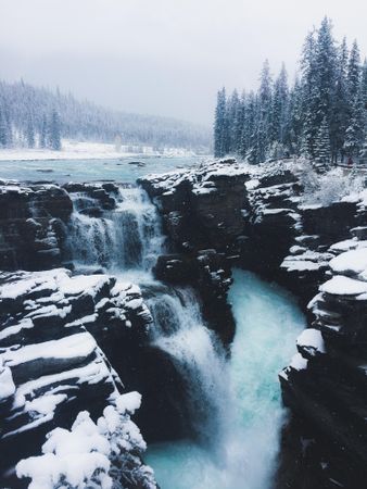 Waterfall on snow covered rocks
