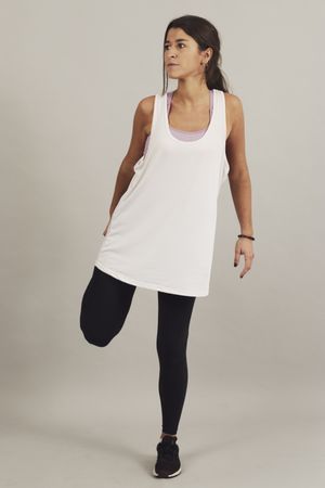 Concentrated young active female athlete exercising in studio