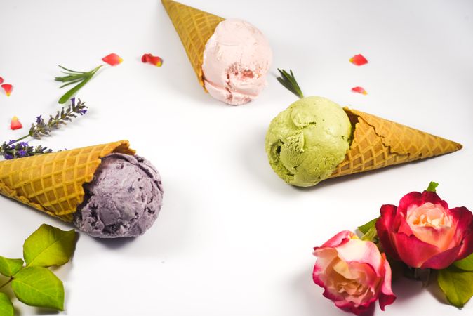Three colorful waffle cones with different ice cream scoops