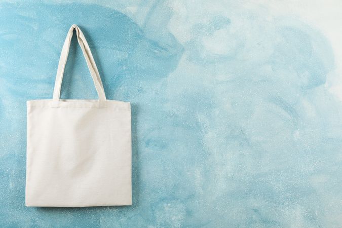 Tote cotton bag on color wall, space for text