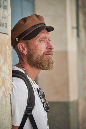 Serious bearded hipster standing on street