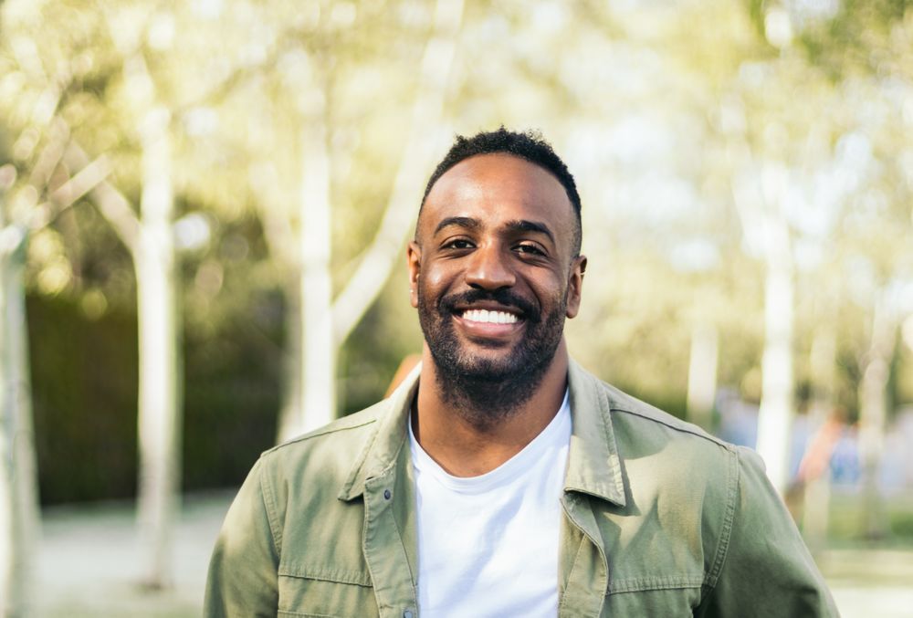 young Black man portrait in a park.