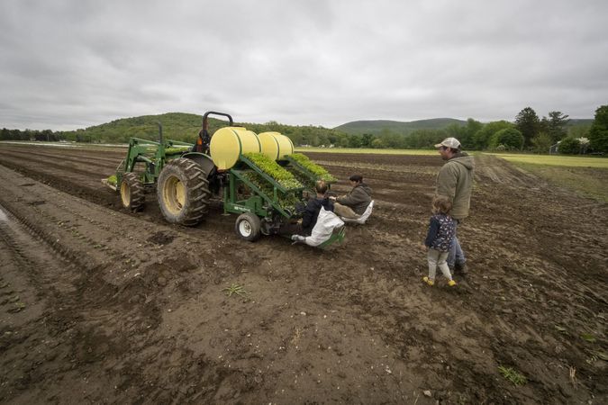Copake, New York - May 19, 2022: Family wiring on farm with tractor