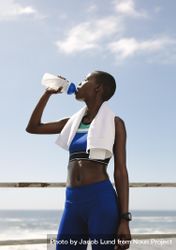 Fit woman drinking water after workout session 4jQVz5