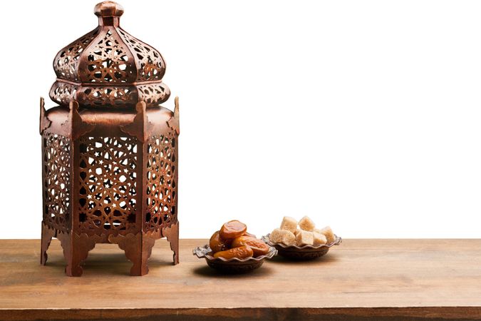 Decorative Lantern with Traditional Snacks on Rustic Wooden Surface