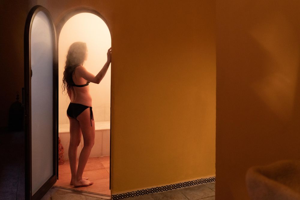 Woman in door of steam room in Arabic spa
