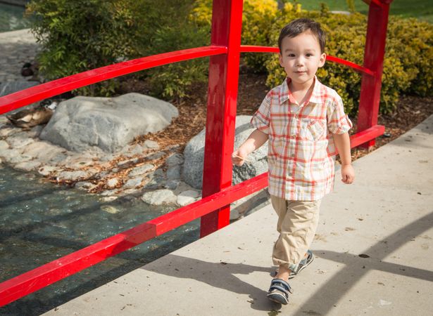 Young Boy Walking at the Park.