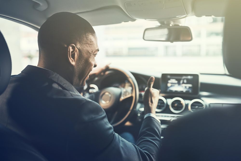Shot of man driving and giving the thumbs up from driver seat