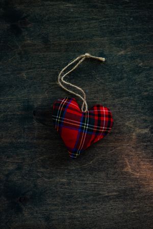 Valentine's day concept of tartan heart decorations on wooden table