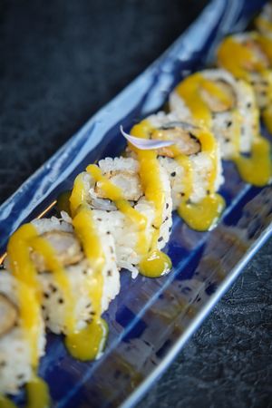 Delicious sushi pieces with battered prawns and soy sauce