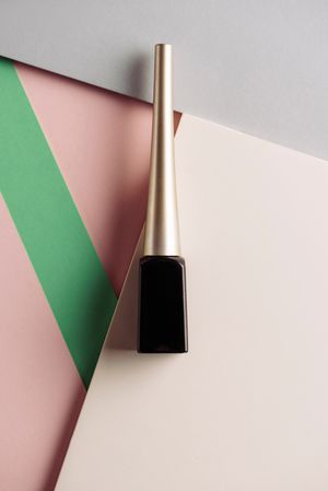 Liquid eyeliner brush on geometric background