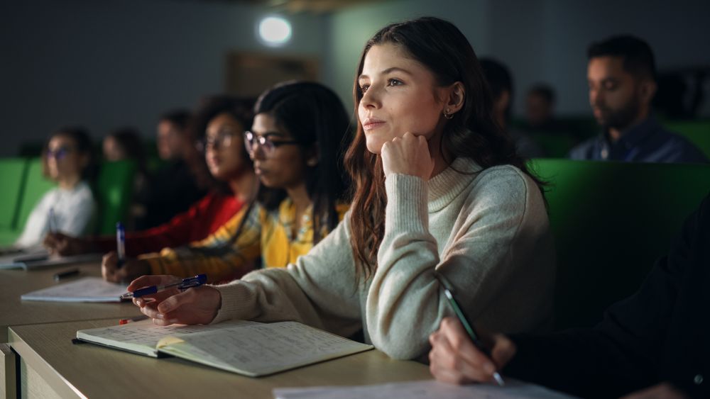 Talented Smart Female Student Studying in College with Diverse Multicultural Colleagues.