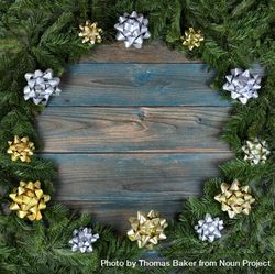 Christmas wreath with bows on blue faded wooden planks bE6eM0