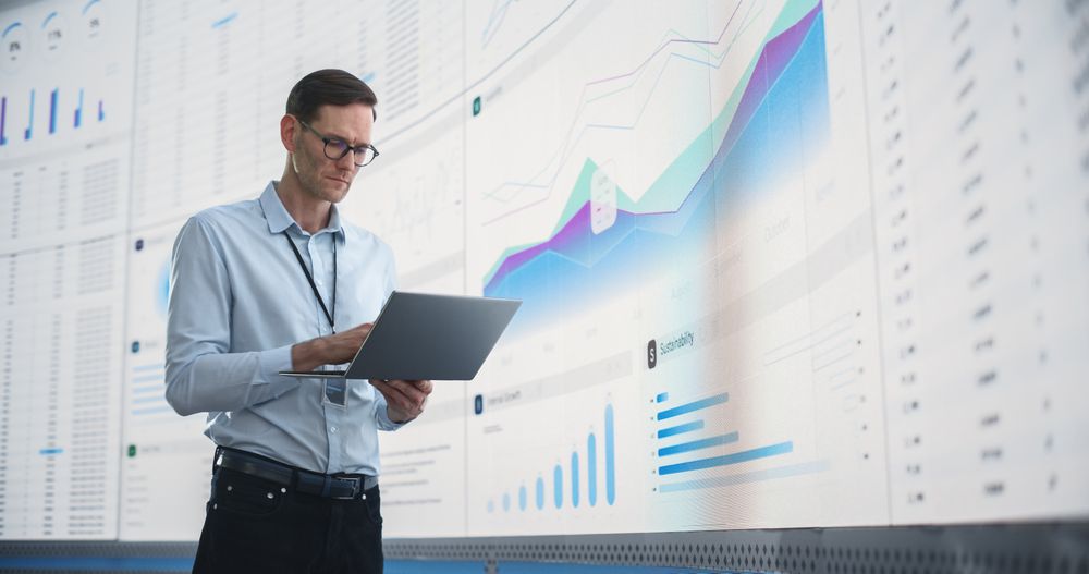 Man Analyzing Data, Performance Records, And Filing Report.