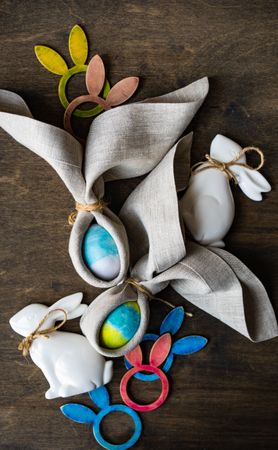 Easter holiday setting of Easter eggs wrapped with rabbit ears with napkin