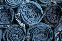 Background of a stack rolled jeans, space for text