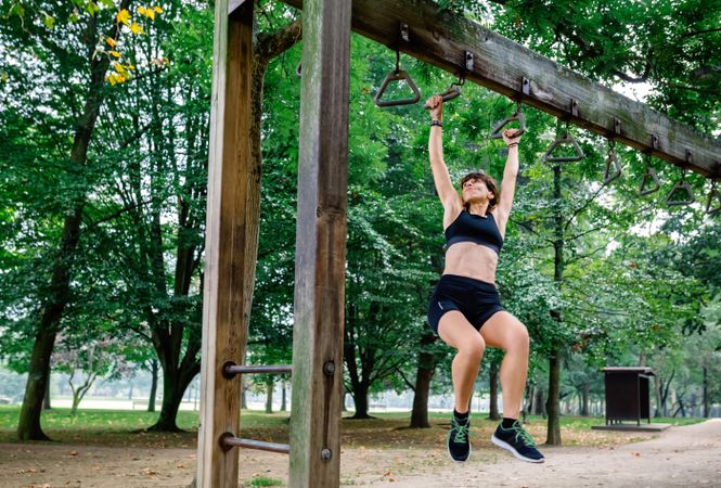 Woman doing monkey exercises on rings