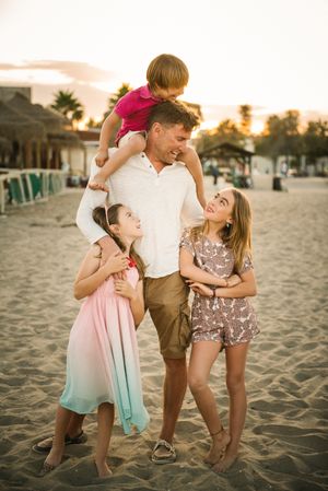 Man with daughters and son on beach
