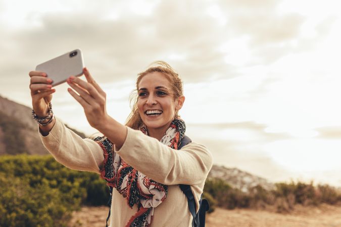 Female hiker taking a selfie for her social media content
