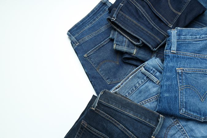 Folded jeans on a light background