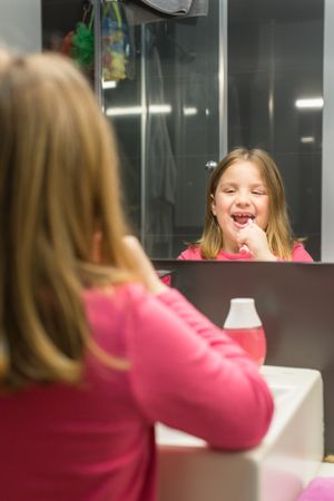 Cute girl brushing her teeth