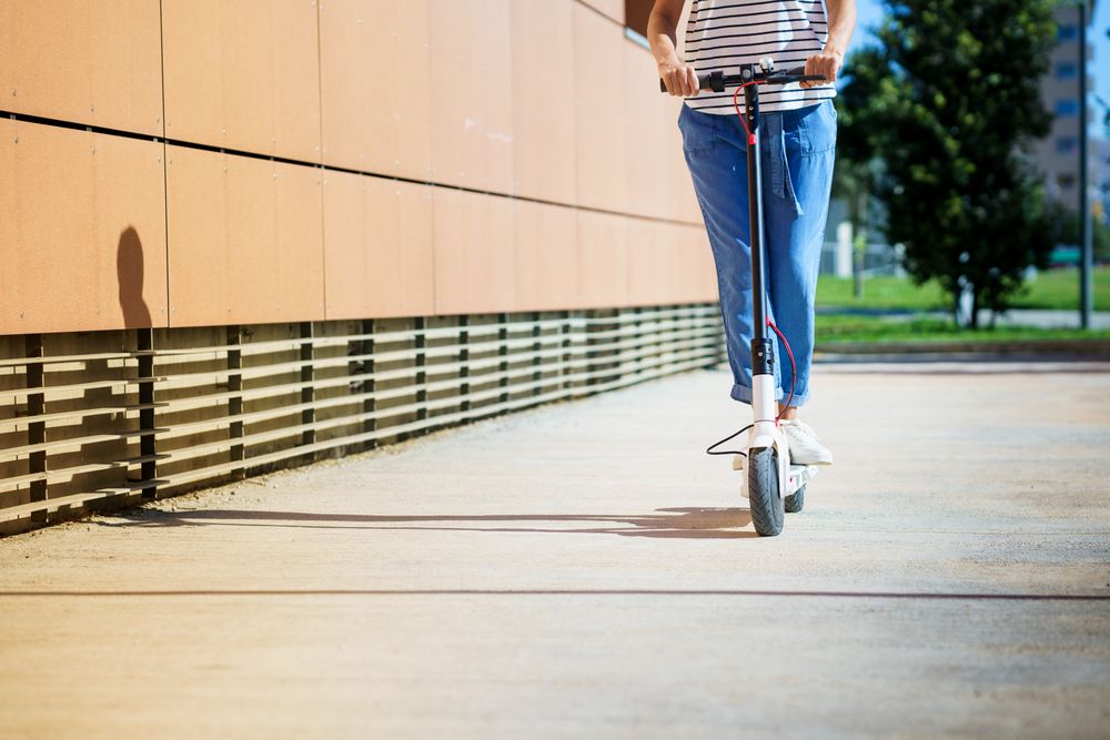 Woman going around the city with an electric scooter