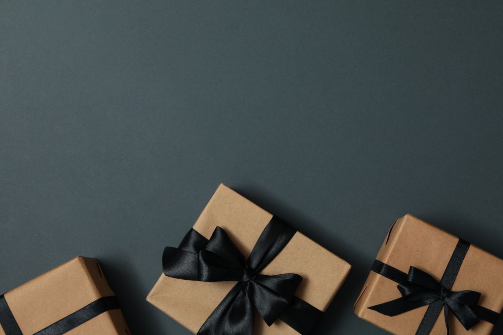 Craft gift boxes with bow on gray background
