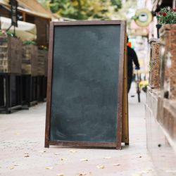 Blank chalk board near cafe