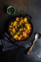 Top view of Georgian meat and vegetable stew Souzi served with herb, with copy space