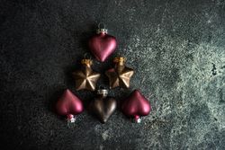 Shape of tree on table made out of pink and gold Christmas baubles